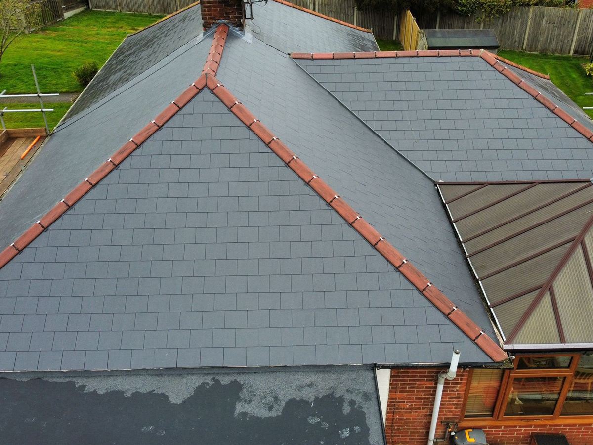 Completed slate-effect roof with red ridge tiles by Validus Roofing